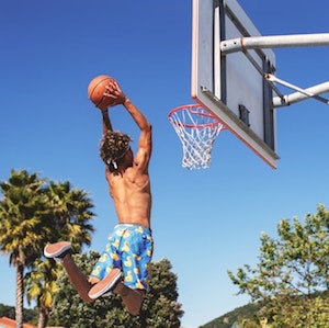 Boy shooting basketball hoops