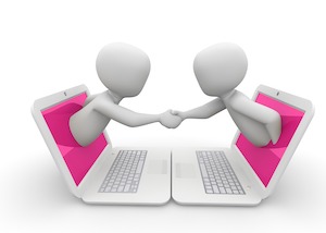 Two characters popping out of laptop screens and shaking hands showing success in virtual selling