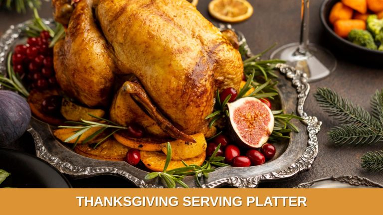 A roasted turkey set on a beautiful silver platter, and decorated with pomegranate and cranberries, ready for Thanksgiving dinner.