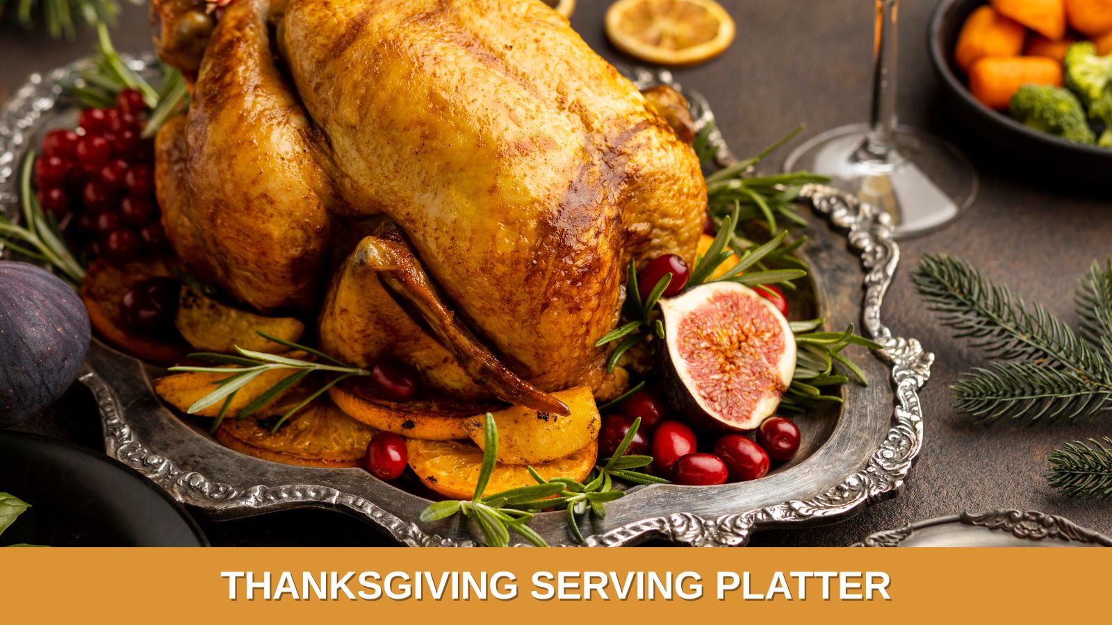 A roasted turkey set on a beautiful silver platter, and decorated with pomegranate and cranberries, ready for Thanksgiving dinner.