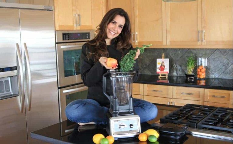 Devin in the kitchen with her blender and fresh produce