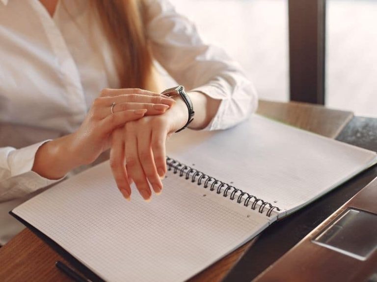 Woman looking at her watch to check the time