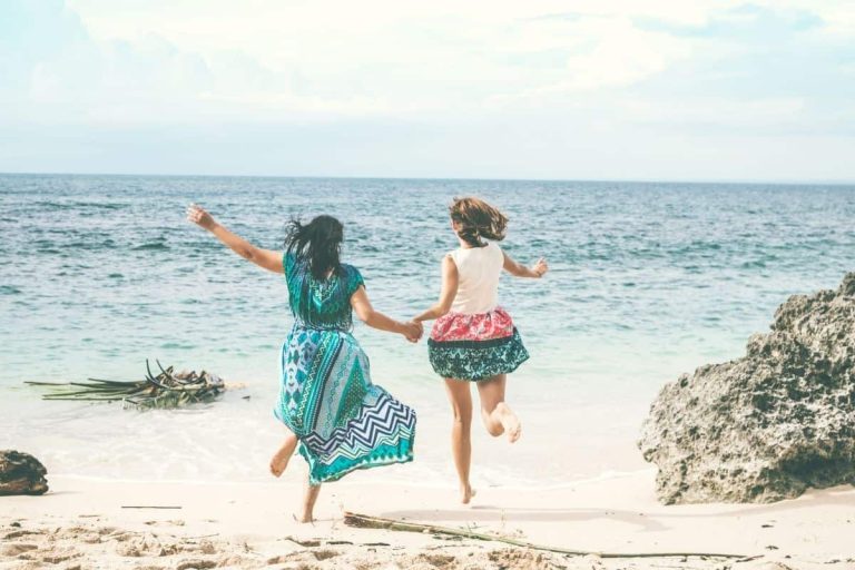 girlfriends running on the beach