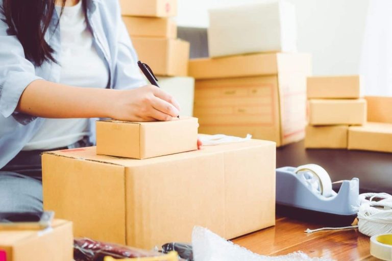 girl with lots of packing boxes around