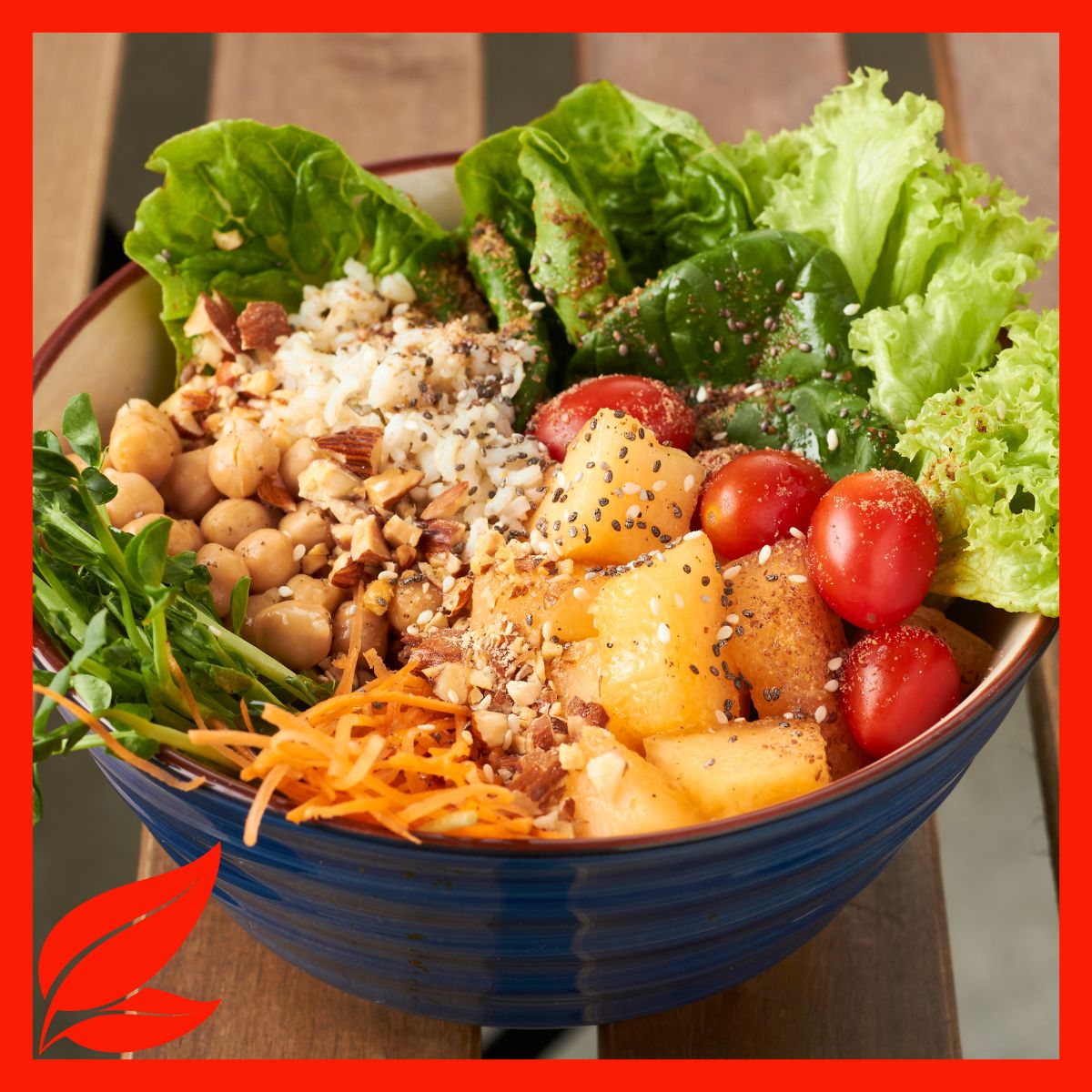 A salad bowl with lettuce, tomatoes, nuts, chickpeas, and more. 