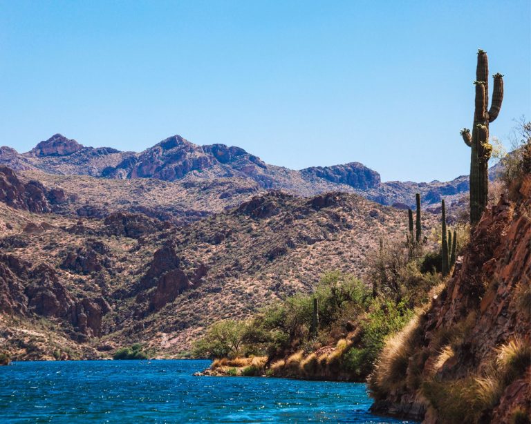 Arizona lake surrounded by rocky hills and cacti.